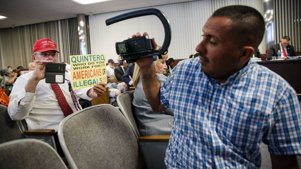Schaper and immigrants' rights activist Naui Huitzilopochtli point their cameras at each other. Huitzilopochtli, of Santa Ana, often shows up at events specifically to record Schaper and other anti-illegal immigrant activists. (Marcus Yam / Los Angeles Times)