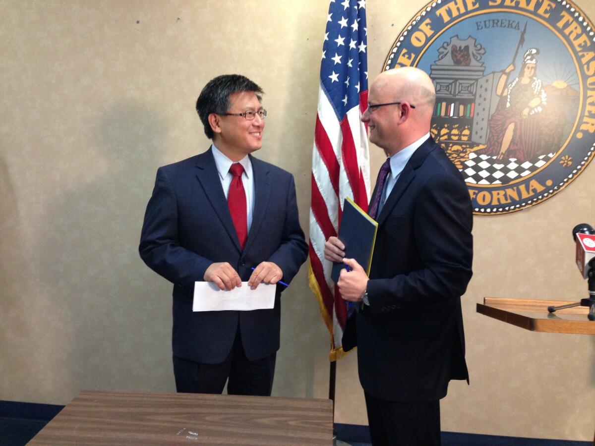 John Chiang, the state treasurer, and Michael Cohen, Gov. Jerry Brown's finance director, chat at an event marking the final payment on debts incurred during California's budget crises.