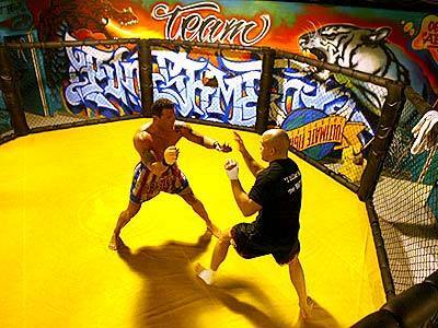 Tito Ortiz, right, goes through a sparring session at the Ultimate Training Center in Huntington Beach. Closed-fist punches to the head are prohibited at the matches in Huntington Beach.