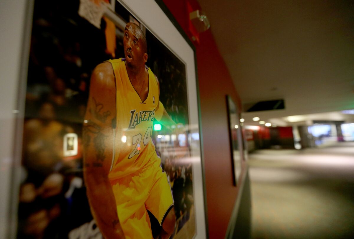 A photograph of Lakers legend Kobe Bryant hangs in an empty concourse at Staples Center during a game Jan. 7, 2021.