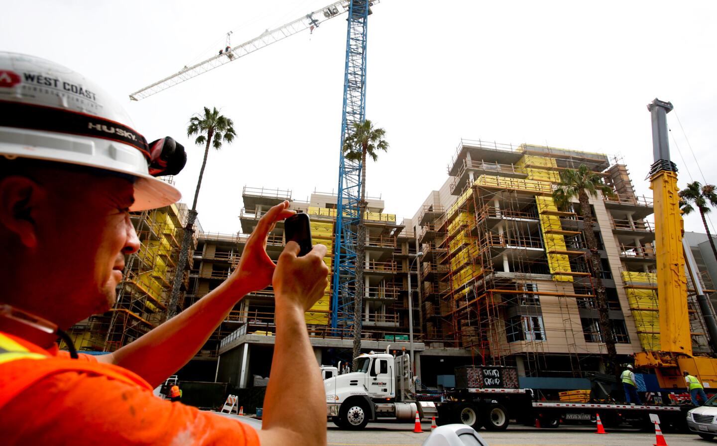 George Solis takes a photo of the Ocean Avenue South project in downtown Santa Monica. It includes two condo complexes: the 93-unit Seachelle development and the 65-unit Waverly.