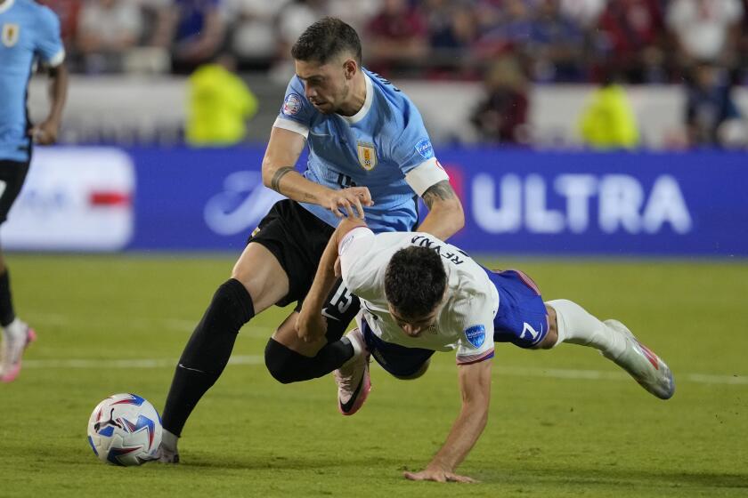 Uruguay's Federico Valverde, left, is challenged by Gio Reyna, right, of the United States.