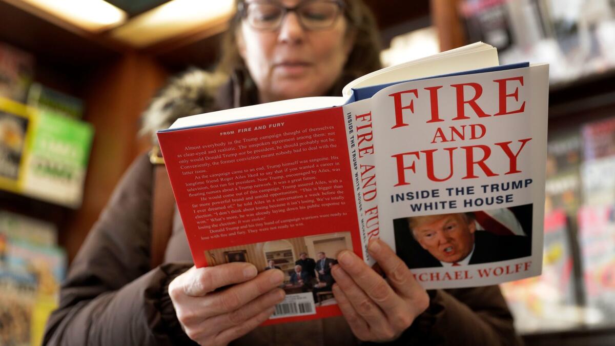 A customer peruses a copy of "Fire and Fury" by Michael Wolff at a Chicago bookstore on Jan. 5.
