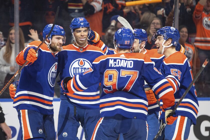 Edmonton Oilers' Leon Draisaitl (29), Darnell Nurse (25), Connor McDavid (97), Devin Shore (14) and Dylan Holloway (55) celebrate a goal against the Florida Panthers during overtime of an NHL hockey game in Edmonton, Alberta, Monday, Nov. 28, 2022. (Jason Franson/The Canadian Press via AP)