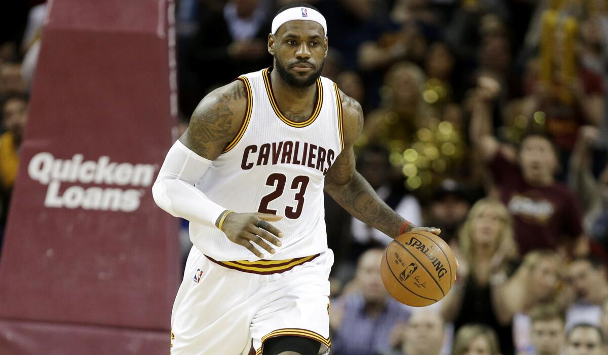 Cavaliers forward LeBron James brings the ball up court against the Raptors on Tuesday.