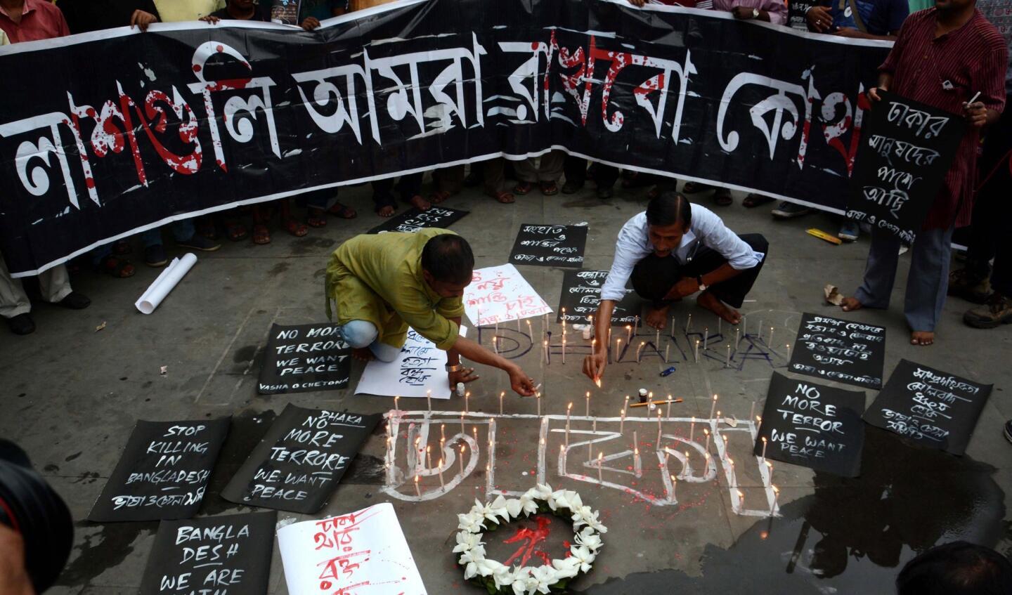 Indian activists in Kolkata light candles in memory of victims of the terror attack in Dhaka, Bangladesh.