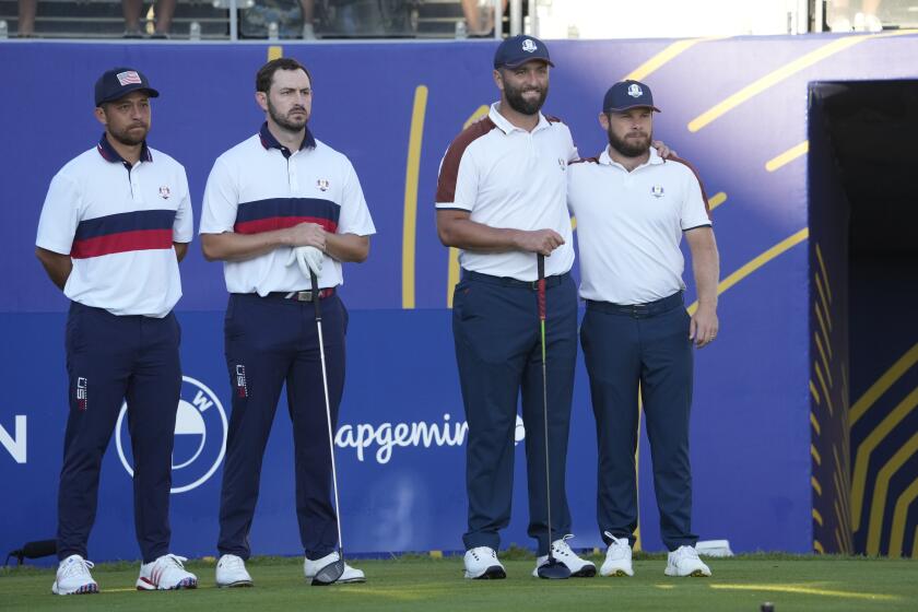 United States' Xander Schauffele, left, with playing partner United States' Patrick Cantlay, and Europe's Jon Rahm, with his playing partner Europe's Tyrrell Hatton, right, pose for the cameras on the 1st tee ahead of their morning Foursomes match at the Ryder Cup golf tournament at the Marco Simone Golf Club in Guidonia Montecelio, Italy, Saturday, Sept. 30, 2023. (AP Photo/Andrew Medichini)