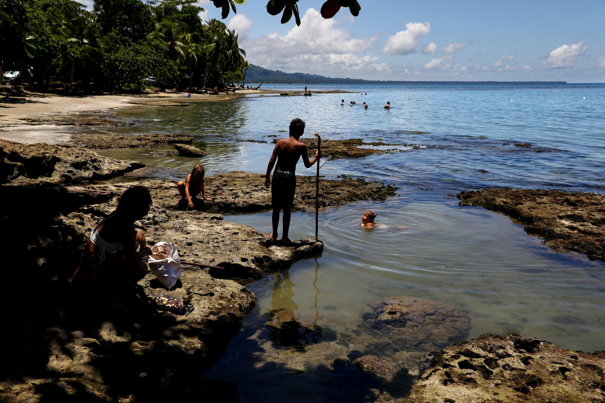 Children wade in tidepools in Puerto Viejo, Limon, Costa Rica.