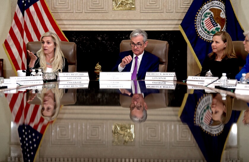 Federal Reserve Chair Jerome H. Powell, center, is flanked by Federal Reserve Govs. Lael Brainard, left, and Michelle Bowman.