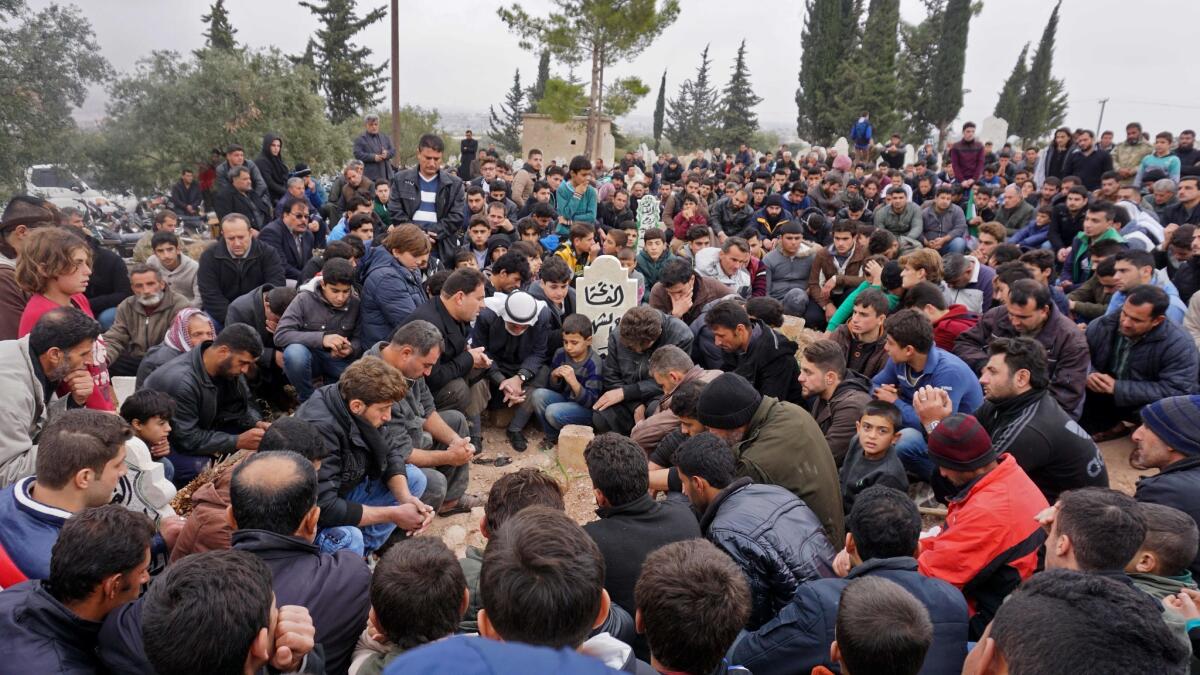 Mourners attend the funeral of Raed Fares and Hamoud Juneid in the village of Kafranbel in the northwestern Syrian province of Idlib on Friday.