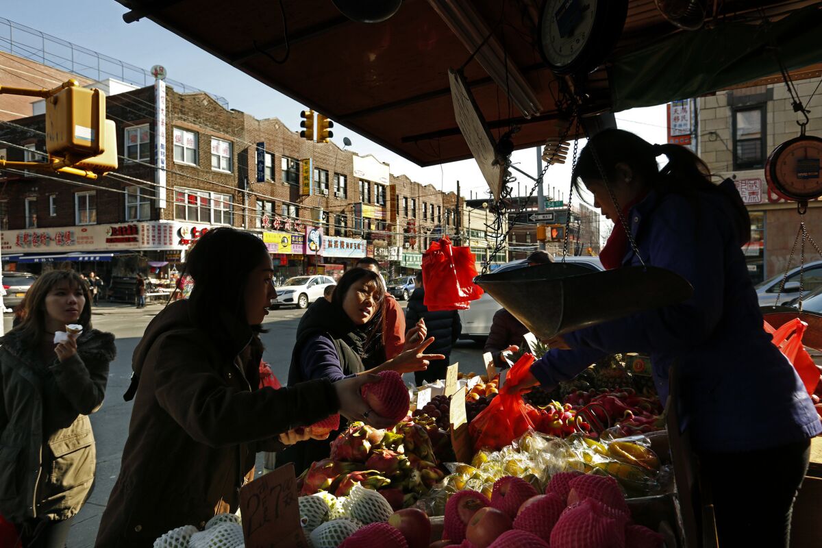 Customers buy fruit along 8th Avenue at 54th Street in Sunset Park.