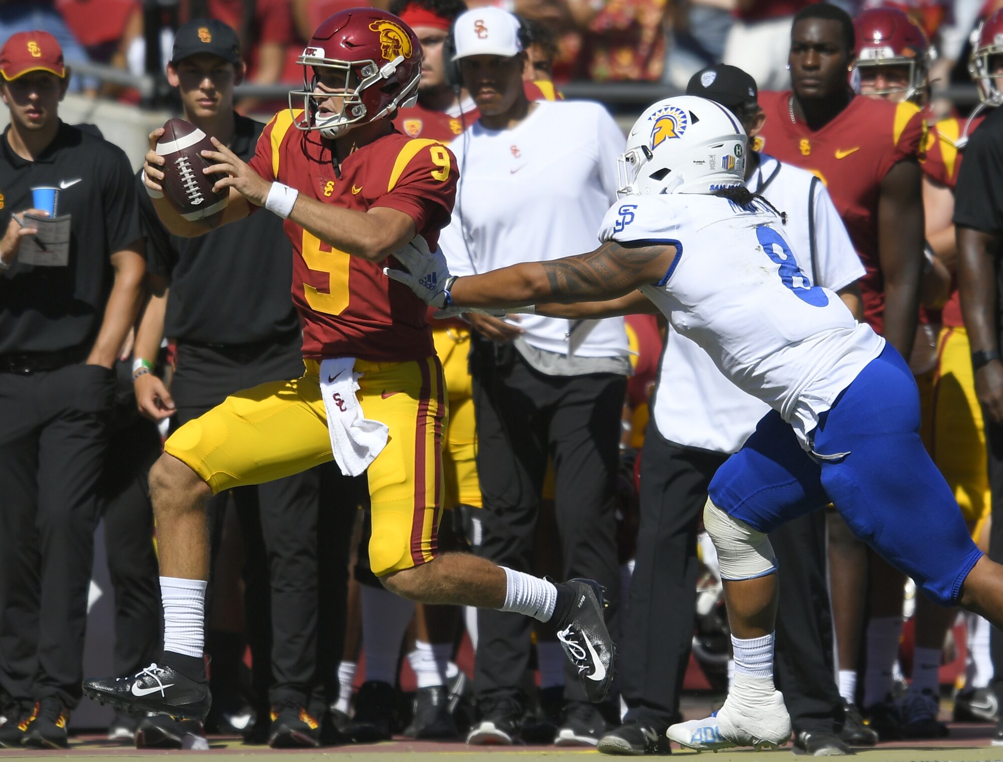 San Jose State Spartans linebacker Alii Matau pushes USC Trojans quarterback Kedon Slovis.
