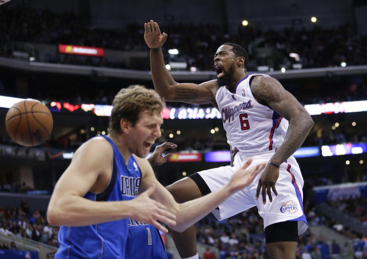 Clippers center DeAndre Jordan (6) screams after making a dunk in front of Mavericks forward Dirk Nowitzki during the first half a 2014 game.