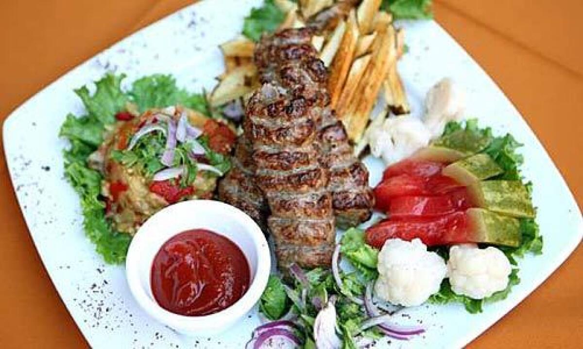 The lulya kebab with French fries, sour watermelon and grilled vegetables at Russian Dacha.