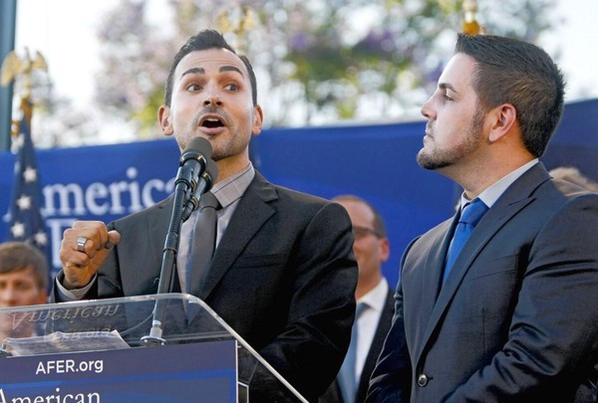 Paul Katami of Burbank, left, and his partner Jeff Zarillo, right, celebrate after the U.S. Supreme Court struck down a key part of the federal Defense of Marriage Act, during a rally in West Hollywood, on Wednesday, June 26, 2013. Katami spoke about his dream to marry his partner soon in Hawaii and of possibly raising children together some day.