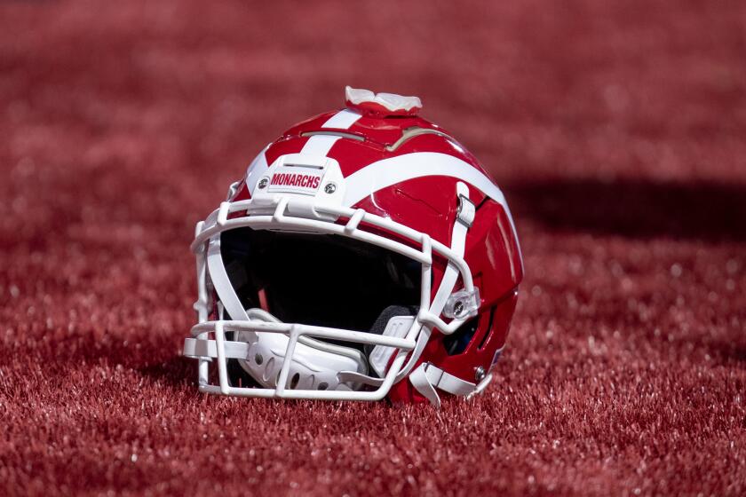 Mission Viejo, CA - December 11: Mater Dei football helmet rests on the turf before the game with San Mateo Serra where they beat them 44-7, winning the 2021 CIF State Football Championship Bowl Games Open Division tournament at Saddleback College, Mission Viejo, CA on Saturday, Dec. 11, 2021. (Allen J. Schaben / Los Angeles Times)