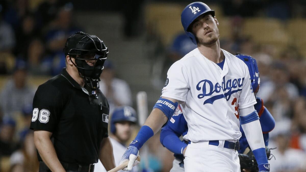 Dodgers' Cody Bellinger, right, laments a called strike en route to striking out during the ninth inning against the Chicago Cubs at Dodger Stadium on Saturday.