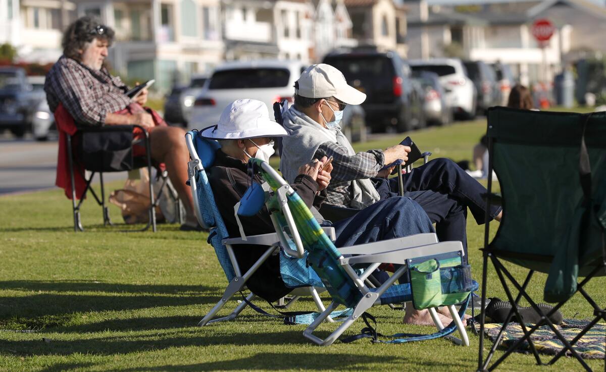 People enjoy the outdoors along Ocean Boulevard in Newport Beach on Friday.