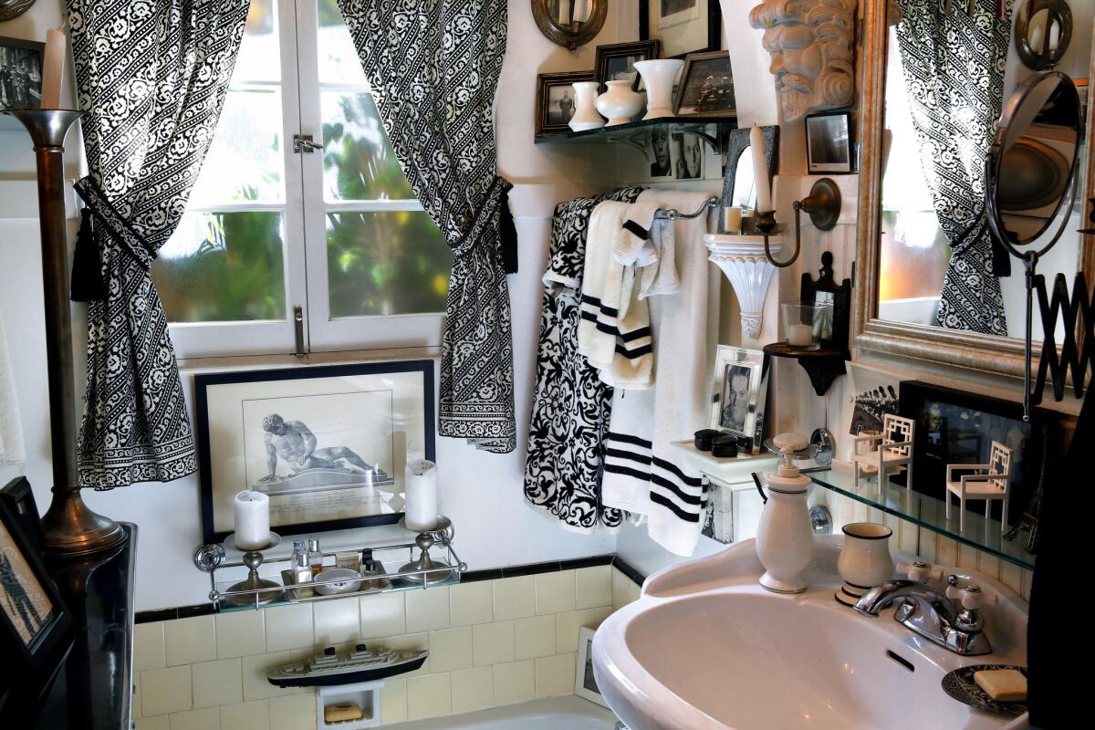 Not every element of the bathroom is vintage. The fabric used on the windows is a black and white print from Ikea and the sink is a contemporary Home Depot model with old-fashioned styling.
