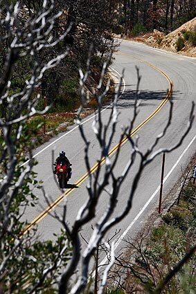 A motorcyclists navigates the hairpin turns of Angeles Crest Highway, which reopened Friday after being shut down for a year and a half. See full story
