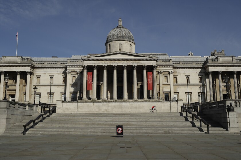 FILE - This Tuesday, March 24, 2020 file photo shows The National Gallery in a deserted Trafalgar Square in London. The British government has announced more than 1.5 billion pounds (almost $2 billion) to help the country’s renowned arts and cultural institutions recover from the coronavirus pandemic, after some theaters and music venues warned that without support they might never open again. (AP Photo/Matt Dunham, File)