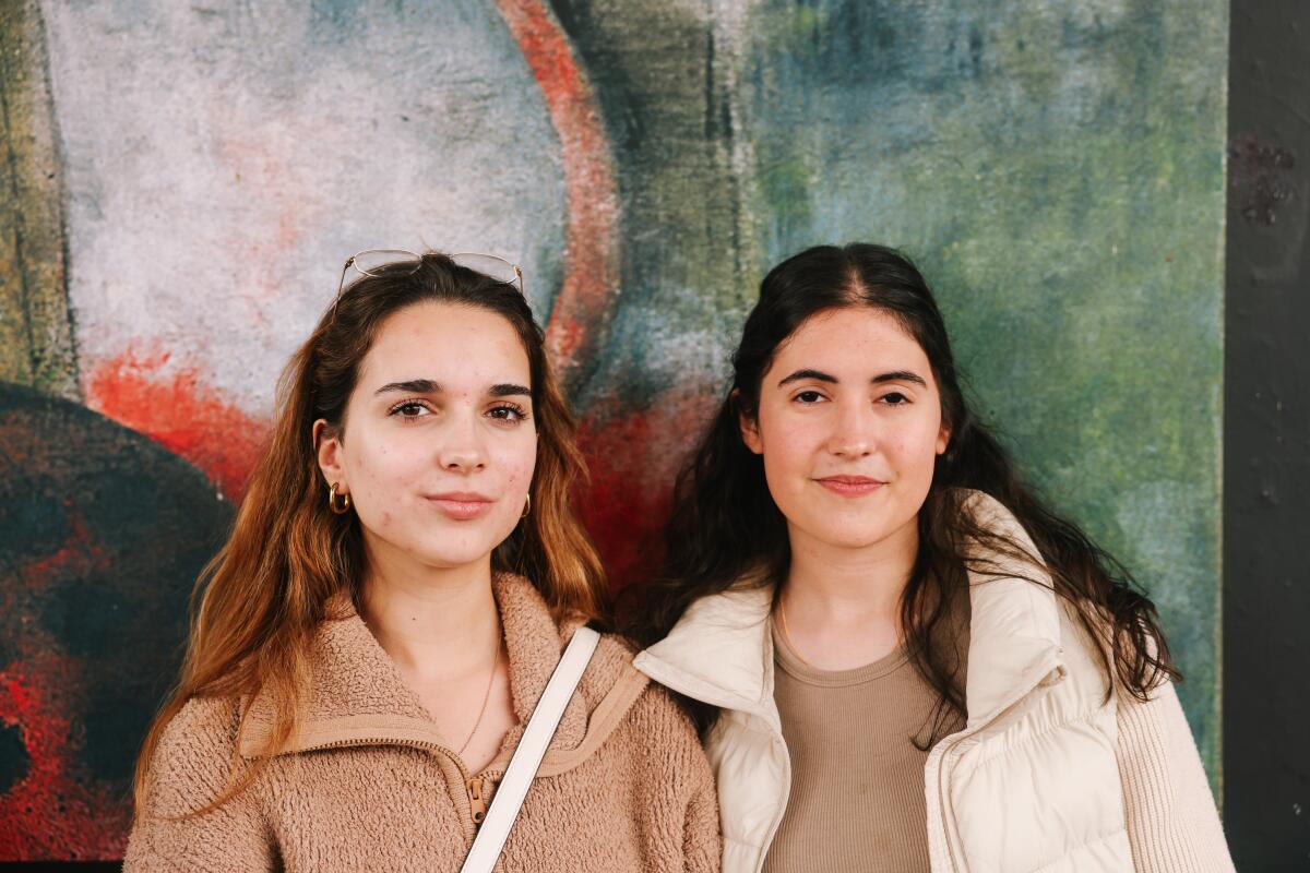 Valeria Jauregui, left, and Carolina Montemayor, right, take a portrait while waiting to vote.