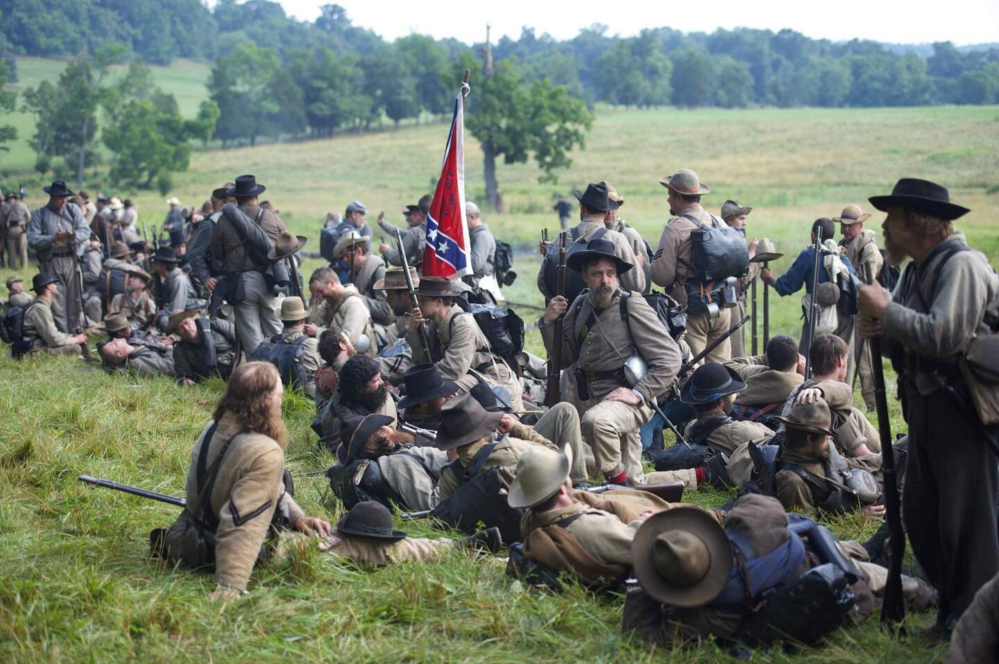 Actors playing Confederate soldiers congregate at a wood's edge awaiting orders to charge during a reenactment of The Battle of Little Roundtop during the Blue Gray Alliance events marking the 150th anniversary of the Battle of Gettysburg, in Gettysburg, Pennsylvania June 30, 2013. The Battle of Gettysburg was fought July 1-3, 1863, in and near the town of Gettysburg, Pennsylvania and was the battle with the highest number of casualties in the Civil War. The Union army defeated a force led by Confederate General Robert E. Lee in what is often described as the turning point of the war. REUTERS/Mark Makela (UNITED STATES - Tags: ANNIVERSARY SOCIETY CONFLICT) ORG XMIT: MM01