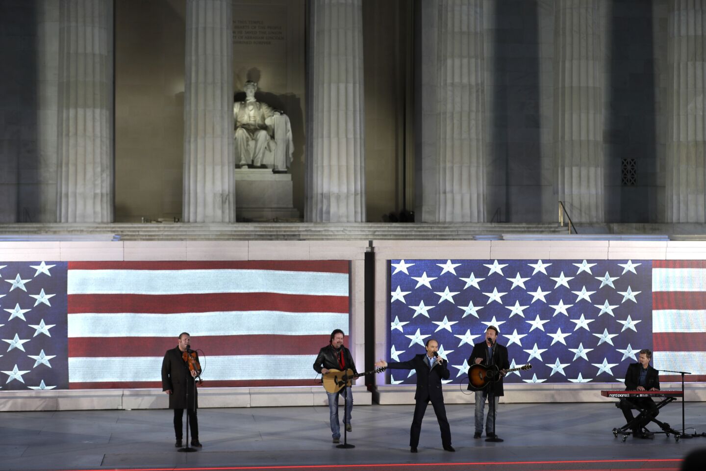 Lee Greenwood, third from left, sings with the backing of the Frontmen of Country.