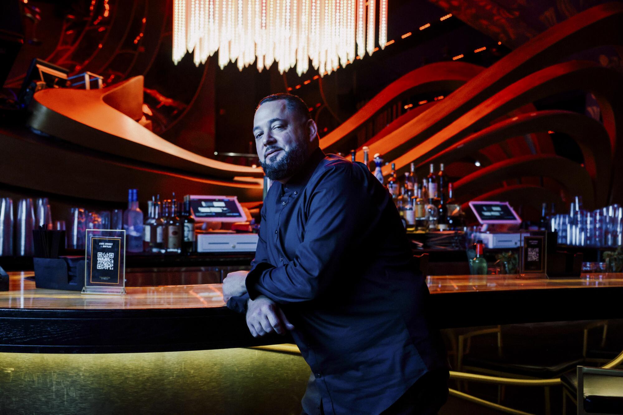 Jesse Saenz leans against the bar at the nightclub inside the Miami Heat arena.
