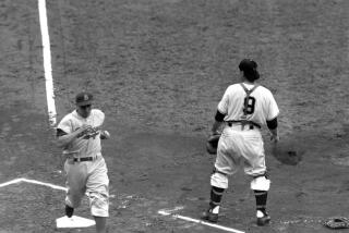 Shortstop Pee Wee Reese of the Brooklyn Dodgers crosses home plate to score the first run of National League tie-breaker series as catcher Wes Westrum of the New York Giants waits for the ball, at the Polo Grounds in New York, Oct. 3, 1951. Reese scored in the first inning on Jackie Robinson's single to left. The Giants bounced back to win the flag with a 5-4 victory as Bobby Thomson smashed a three-run homer in the ninth inning. (AP Photo)