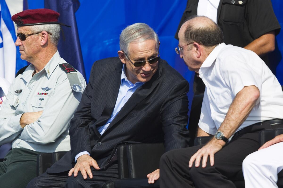 Lt. Gen. Benny Gantz, left, Israel's army chief of staff, appears with Prime Minister Benjamin Netanyahu, center, and Defense Minister Moshe Yaalon at a naval base in Haifa on Sept. 23. Netanyahu called in Gantz and Shin Bet chief Yoram Cohen on Nov. 12 to order an end to a public squabble.