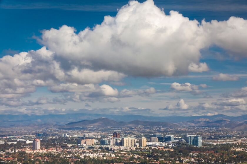 Against a backdrop of billowing clouds left over from the Wednesday rains,The University City and surrounding areas are seen from the Mt Soledad National Veterans Memorial in the La Jolla community of San Diego, California, December 5, 2019.