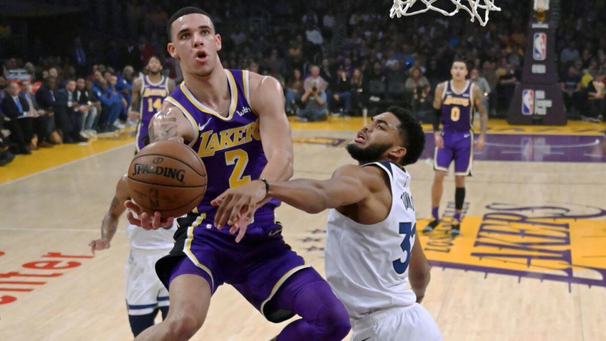 Lakers guard Lonzo Ball tries to score against Minnesota Timberwolves center Karl-Anthony Towns during their game Wednesday.