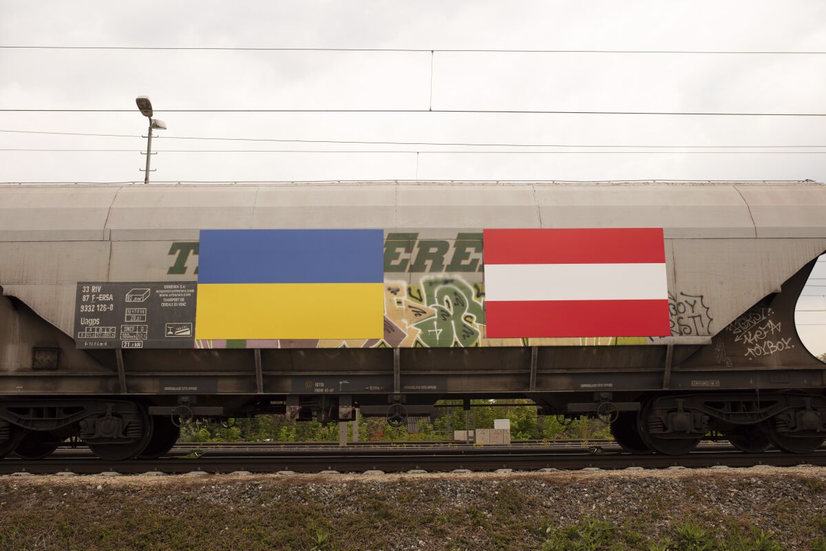 A Ukrainian an Austrian flag is painted on a freight train with fodder maize, arriving from the Ukraine in Vienna, Austria, Friday, May 6, 2022. (AP Photo/Theresa Wey)