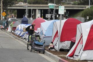 A homeless encampment on the south side of Oceanside Blvd. with I-5 traffic in the background all adjacent Monday to an out reach event featuring services from human services organizations to homeless people in Oceanside. photo by Bill Wechter