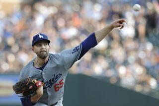 Los Angeles Dodgers' James Paxton pitches against the Detroit Tigers.