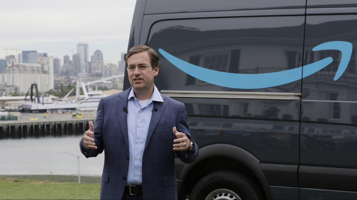Dave Clark, an Amazon executive, talks in Seattle on Wednesday about a new program for entrepreneurs to use Amazon Prime-branded vans and get support from the company as they form businesses to deliver company packages.