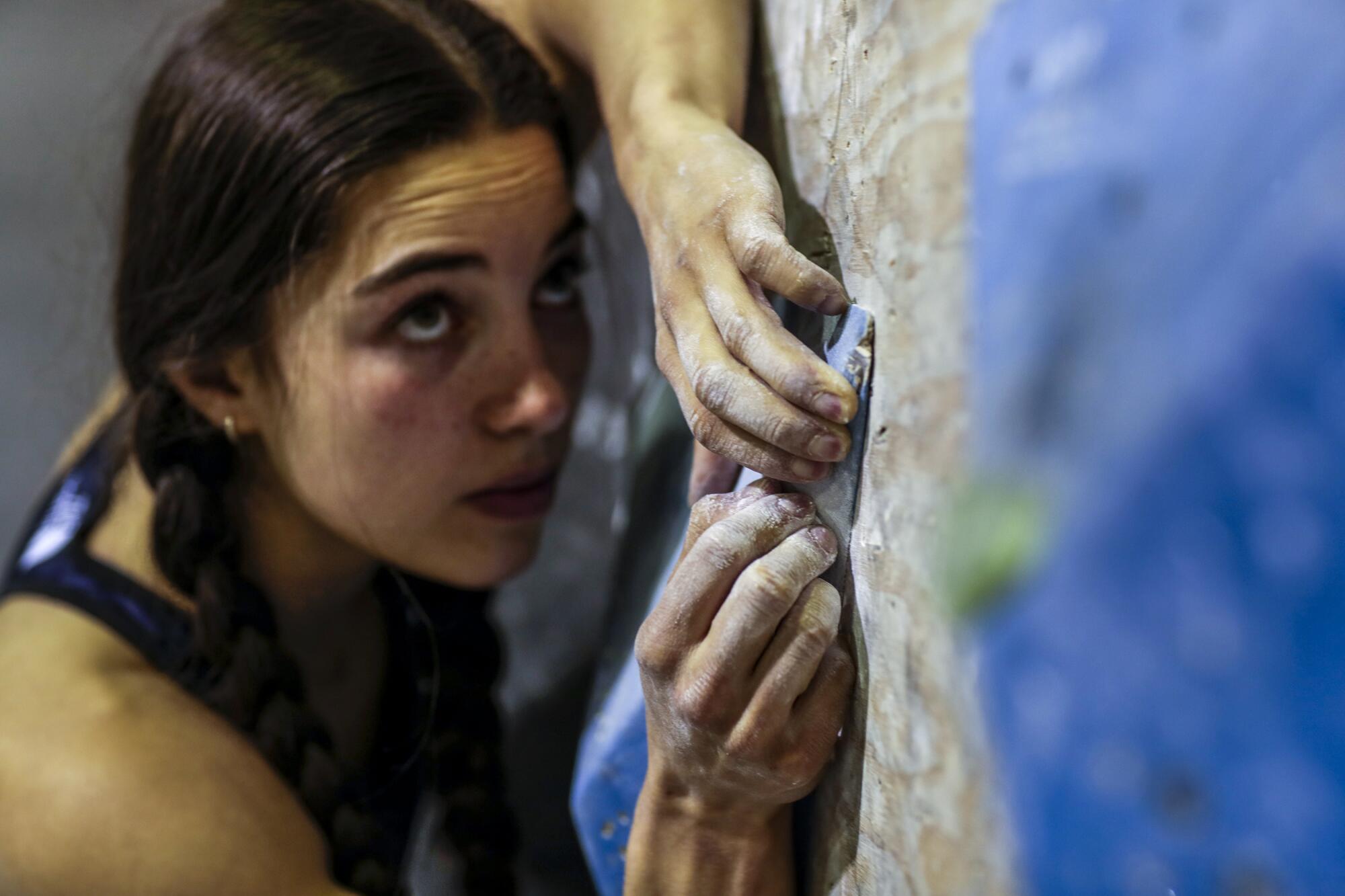 U.S. sport climber Brooke Raboutou scales a wall, also known as a "problem" to competitive climbers.