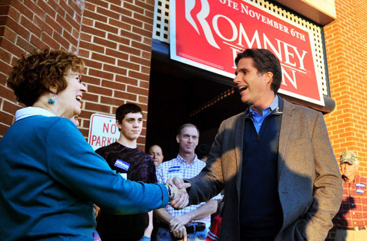 Tagg Romney greets Barbara Irby at his father's election headquarters in Lynchburg, Va., last month.