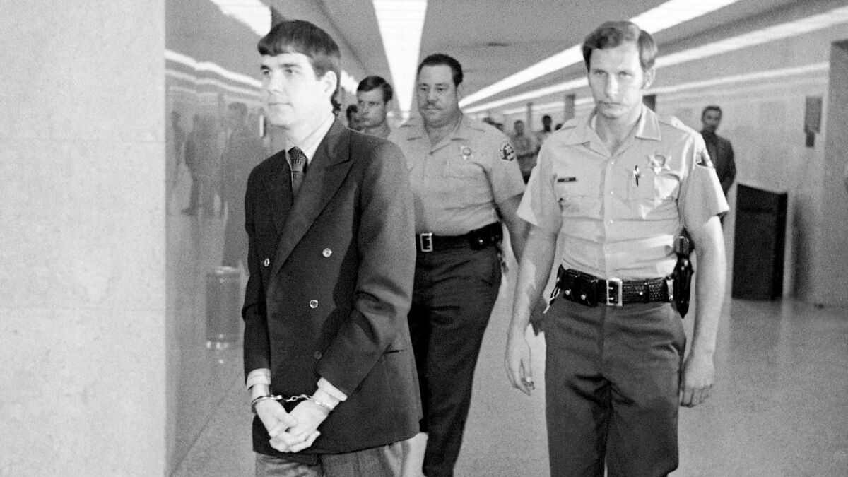 In this 1971 file photo, Charles "Tex" Watson, left, is led back to jail from a courtroom after he was convicted of seven counts of first-degree murder and one count of conspiracy to commit murder.