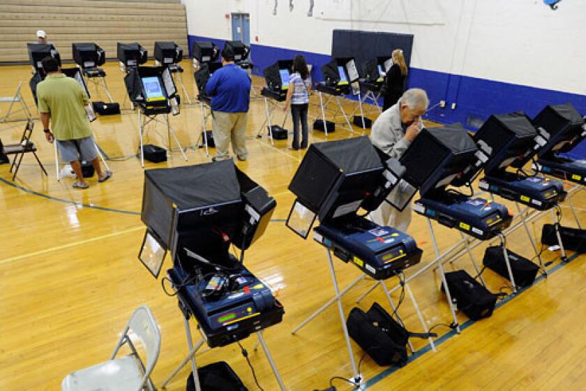 Voters cast their ballots at the polling station at John Fremont Middle School in Las Vegas.