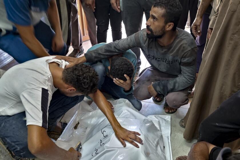 Palestinians mourn a relative killed in the Israeli bombardment of the Gaza Strip, at a hospital in Khan Younis, Saturday, Aug. 24, 2024. (AP Photo/ Mohammad Jahjouh)