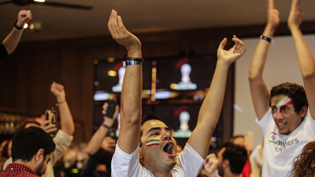 Masoud Akhoondi celebrates Iran's World Cup win with friends at the Parlor bar Friday in Hollywood.