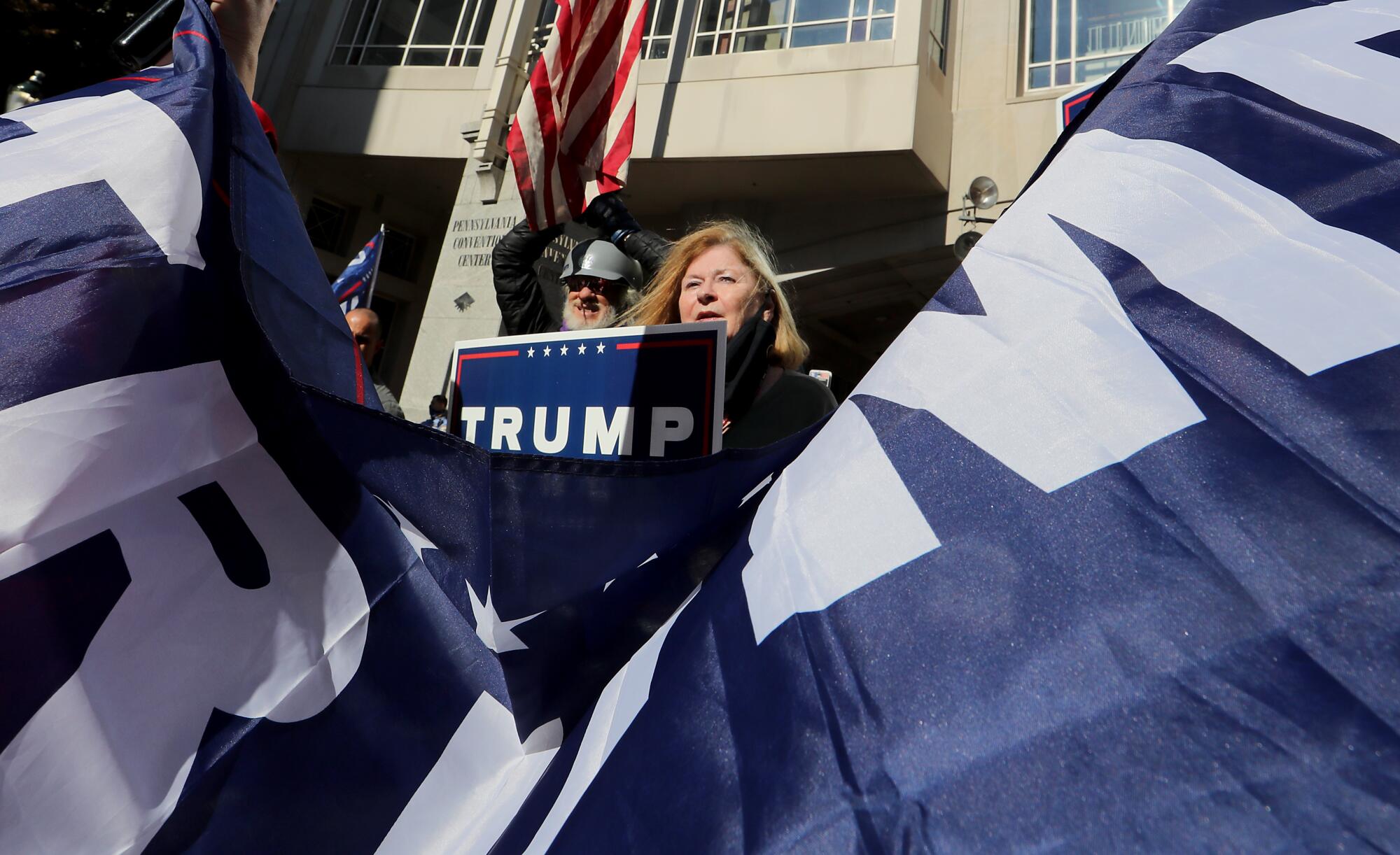 A supporter of President Trump holds up a sign outside the Pennsylvania Convention Center in Philadelphia on Friday.