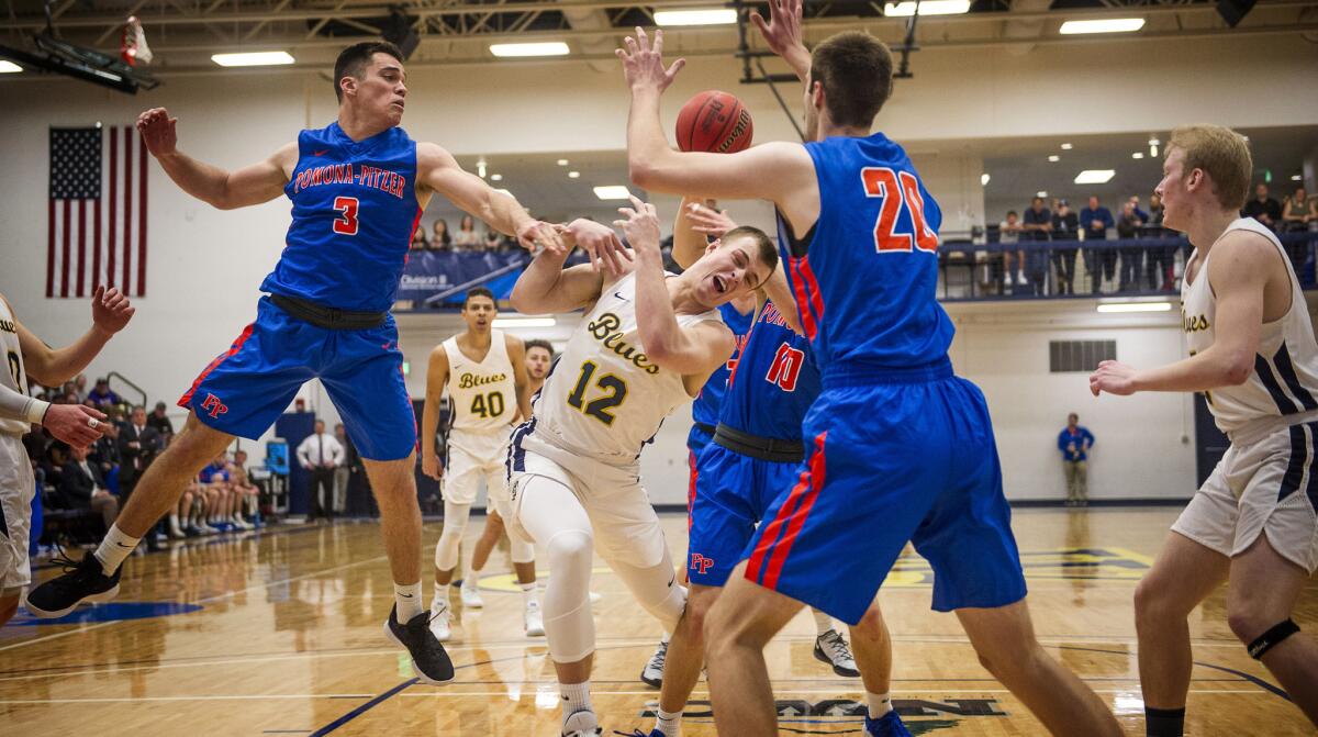 Whitman College's Robert Colson, center, battles for a rebound against Pomona-Pitzer during Whitman's 83-74 victory in the NCAA Division III tournament on Saturday.
