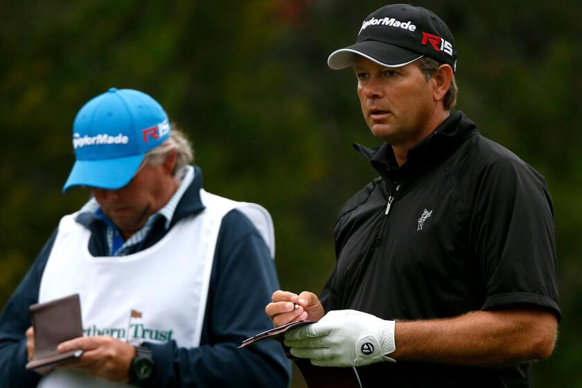 Retief Goosen, right, prepares to tee off at No. 4 during the first round of the Northern Trust Open on Thursday at Riviera Country Club.
