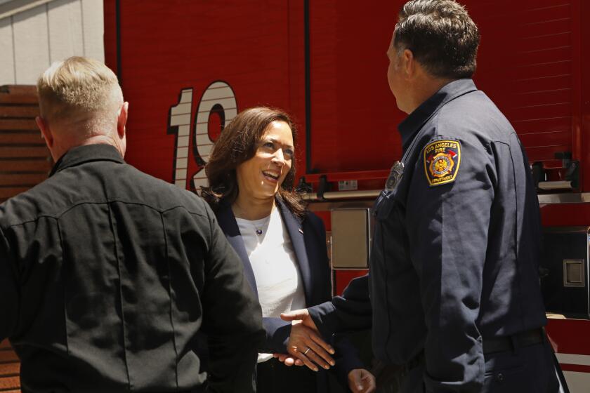 Los Angeles, California-July 4, 2021-Vice President Kamala Harris shakes hands with fiefighter Eric Homsher at Los Angeles Fire Department Station 19, where she stopped to thank firefighters for their their service to their community during a stop in Los Angeles, California on July 4, 2021. (Carolyn Cole / Los Angeles Times