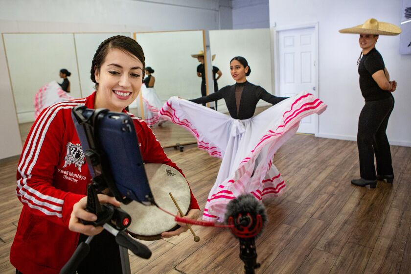MONTEBELLO, CA - APRIL 30: From Left - Ballet Folklorico founder and director Kareli Montoya, 30, of Los Angeles and her instructors Cynthia Contreras, 18, and Erick Vaca, 27, both of Los Angeles continue to teach dance classes via Zoom during the coronavirus pandemic on Thursday, April 30, 2020 in Montebello, CA. (Jason Armond / Los Angeles Times)