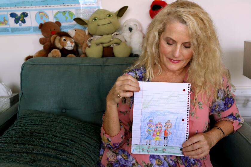 SANTA MONICA, CA - OCTOBER 1, 2020 Jayne Amelia Larson, a volunteer Court Appointed Special Advocate with CASA, holds a drawing created by a young client she works with in the program. Larson advocates for children and young people in the foster system who have been abused and neglected. Larson is an actor, writer and independent film producer. She wrote the New York Times bestseller, "Driving the Saudis." She was photographed in Santa Monica on October 1, 2020. (Genaro Molina / Los Angeles Times)