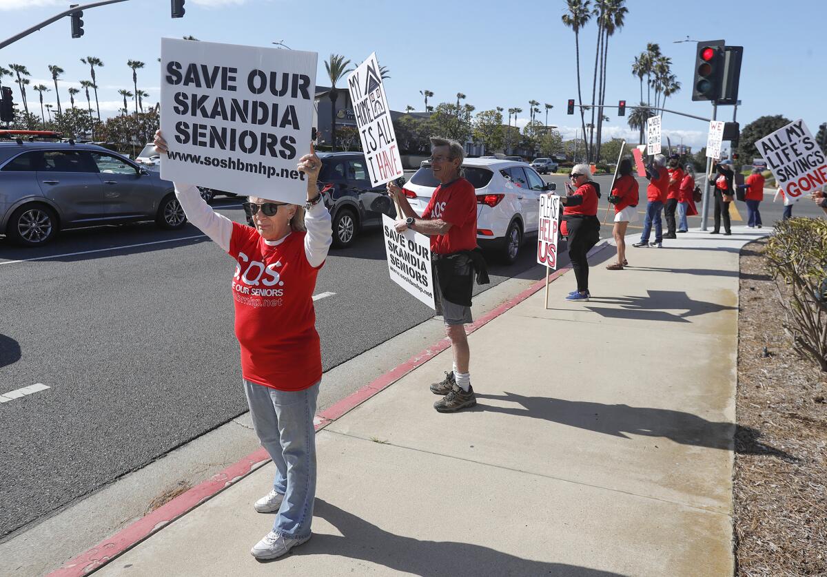 Members of the Mobile Home Resident Coalition rally at Yorktown and Main Street in Huntington Beach on Tuesday.